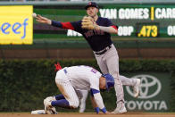 Boston Red Sox second baseman Trevor Story, right, throws to first base after forcing out Chicago Cubs' Nico Hoerner at second base during the fourth inning of a baseball game in Chicago, Saturday, July 2, 2022. Chicago Cubs' Yan Gomes was safe at first base. (AP Photo/Nam Y. Huh)