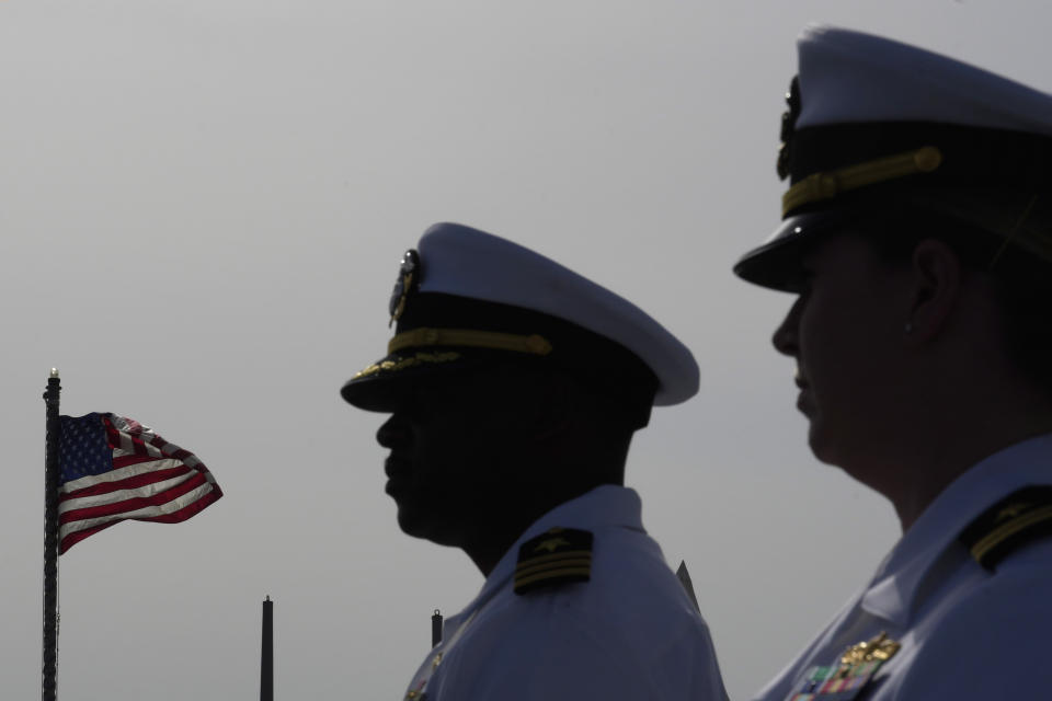 Commander Tyrchra Bowman, left, and weapons officer Lt. Lindsey Boyle stand on the missile destroyer USS Arleigh Burke, docked in the port in southern city of Limassol, Cyprus, Wednesday, May 17, 2023. (AP Photo/Petros Karadjias)