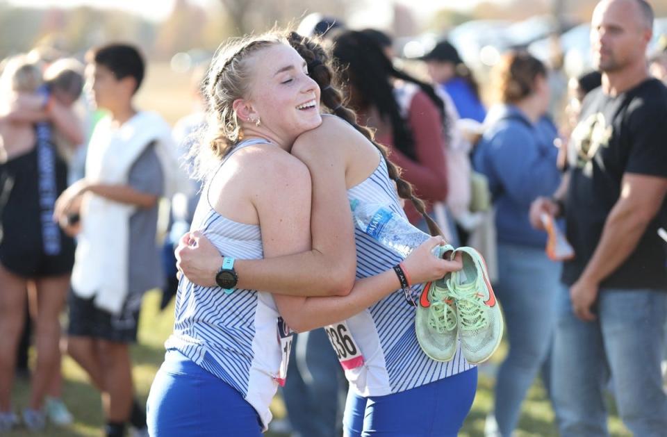 Danville’s Kamryn Gourley gets a hug from teammate Alaina Gourley after the Class 1A State Qualifier at Iowa City. Both girls qualified to compete in the state cross country meet. Gourley finished second and Sherwood placed seventh.