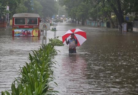 A man wades through a water-logged road during rains in Mumbai, August 29, 2017. REUTERS/Shailesh Andrade/Files