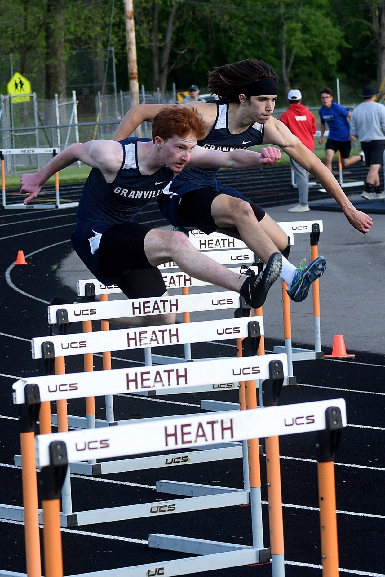 Granville seniors Grayson Penland (center) and Theron Rogerson (right) clear their hurdles during the 300 hurdles at the Licking County League track championships on Friday, May 14, 2021. The Inaugural Run for Theron 5K and 1-mile race will be held at 6 p.m. on June 17 at Granville High School in honor of Rogerson, a 2021 GHS graduate who died by suicide in May 2022.