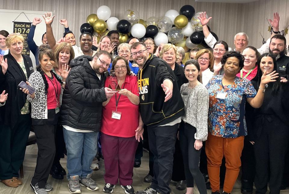 Linda McNutt, front center, celebrates 50 years at the Webster Park Rehabilitation and Nursing Center in Rockland with staff and management. Her two sons are by her one on each side.