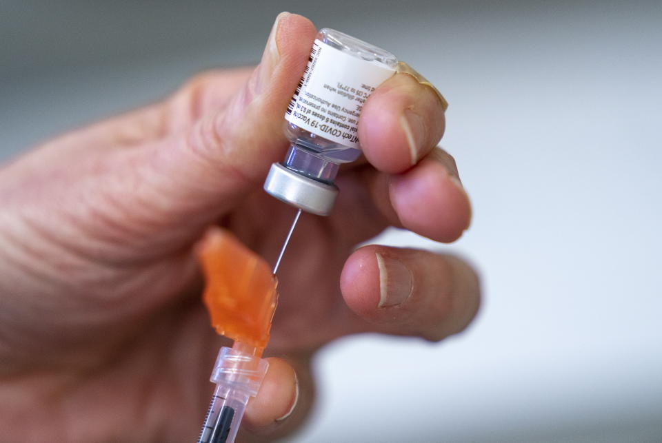 In this Saturday, April 10, 2021 photo, a syringe is loaded with the Pfizer-BioNTech COVID-19 vaccine at a clinic in Richmond, British Columbia, Canada. On Wednesday, May 5, 2021, Canada’s health regulator authorized the Pfizer vaccine for ages 12 and older. (Jonathan Hayward/The Canadian Press via AP)