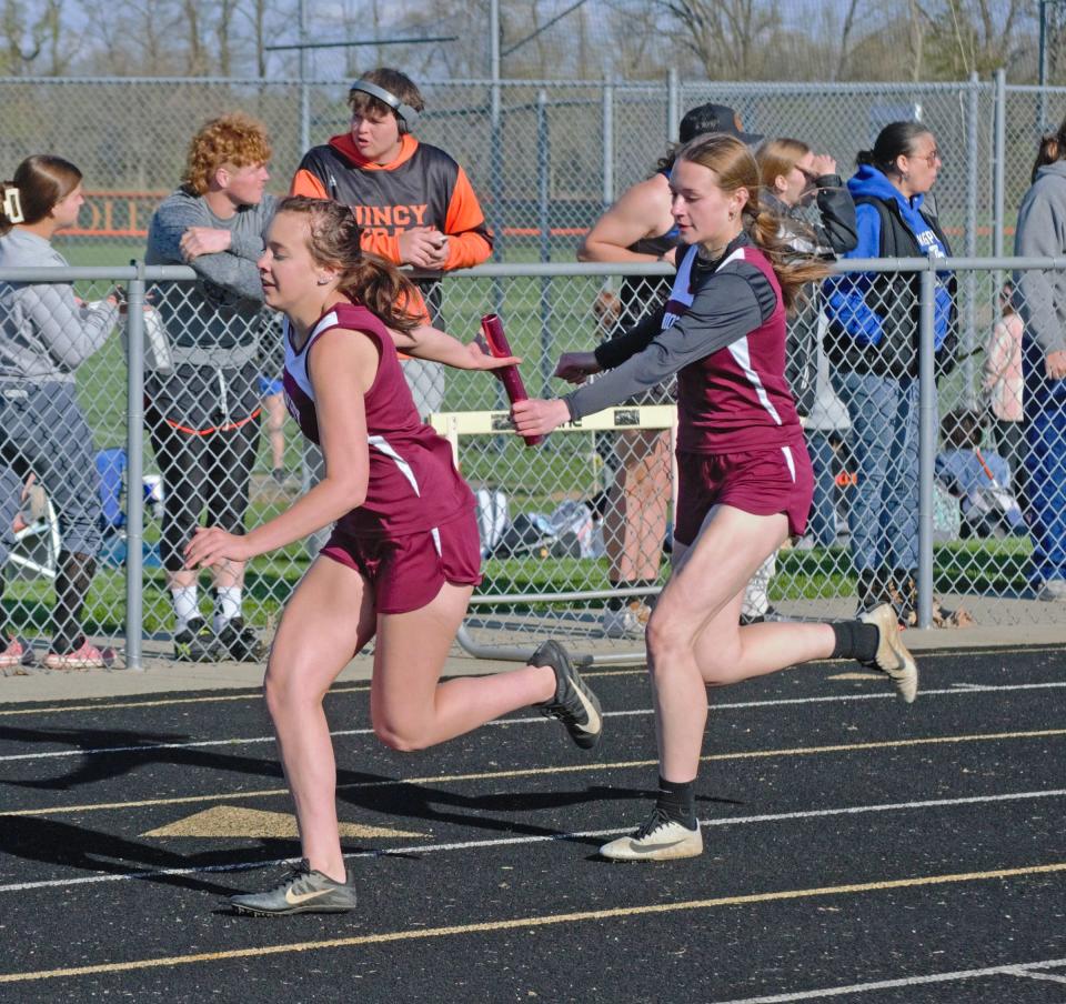 Union City's Addy Rumsey hands off to teammate Addison Meyer during the 400 meter relay on Wednesday