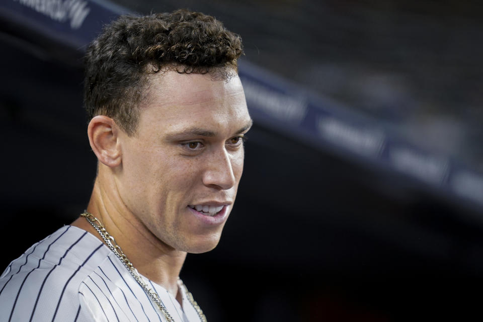 New York Yankees' Aaron Judge smiles in the dugout after hitting a solo home run off Cleveland Indians starting pitcher Zach Plesac during the fourth inning of a baseball game Friday, Sept. 17, 2021, in New York. (AP Photo/John Minchillo)