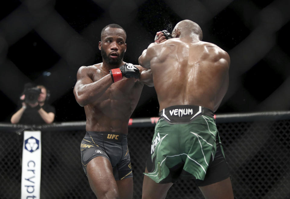 Leon Edwards, left, in action against Kamaru Usman during their welterweight title bout during UFC 286 mixed martial arts event at O2 Arena, in London, Saturday, March 18, 2023. (Kieran Cleeves/PA via AP)