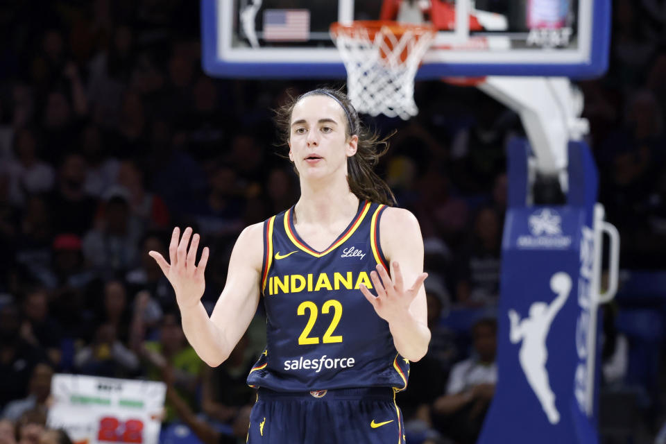 CORRECTS FROM CAITLYN TO CAITLIN - Indiana Fever guard Caitlin Clark reacts after making a basket during the first half of an WNBA basketball game against the Dallas Wings in Arlington, Texas, Friday, May 3, 2024. (AP Photo/Michael Ainsworth)