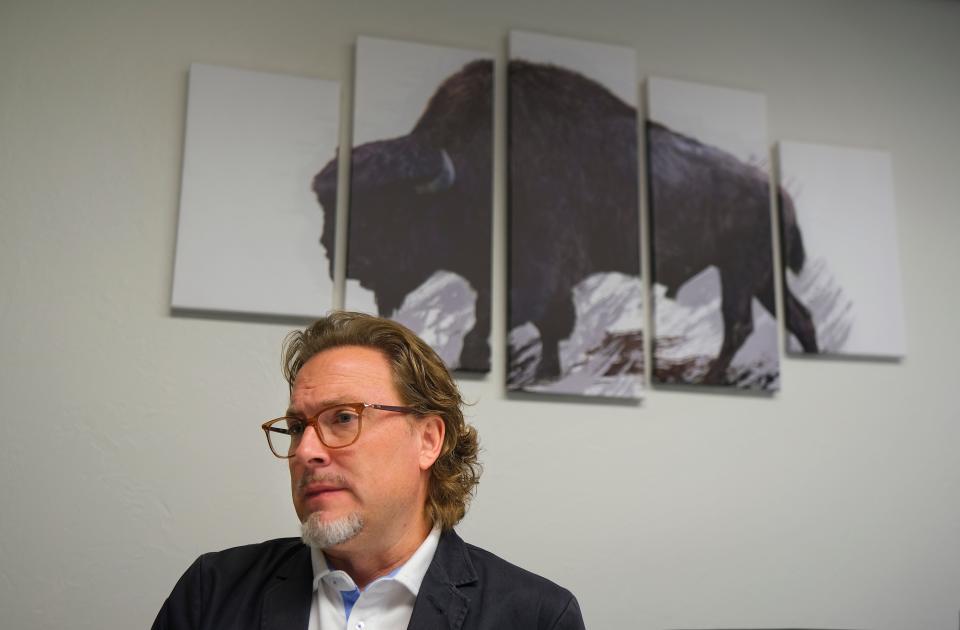 With artwork of a bison, Oklahoma Baptist University's mascot, in the background, Oklahoma Baptist University President Heath Thomas talks about ongoing storm repair in the aftermath of a tornado that damaged the Shawnee college on April 19.