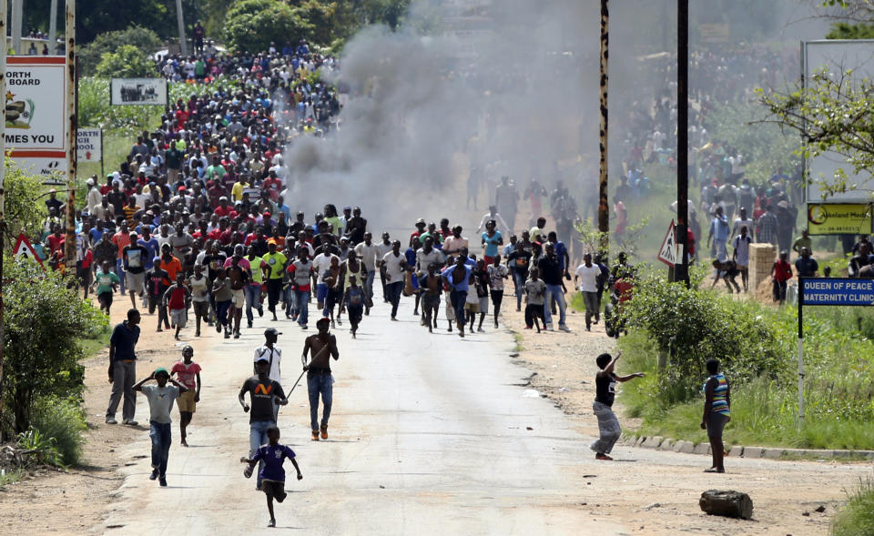 Protestors gather on the streets during demonstrations over the hike in fuel prices in Harare, Zimbabwe, Monday, Jan. 14, 2019. Protesters have blocked roads in some parts in Zimbabwe's capital after the government more than doubled the price of gasoline. (AP Photo/Tsvangirayi Mukwazhi)