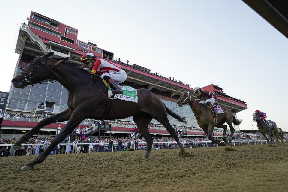 Jose Ortiz, left, atop Early Voting, edges out Joel Rosario, second from right, atop Epicenter, and Brian Hernandez Jr., right, atop Creative Minister, to win during the 147th running of the Preakness Stakes horse race at Pimlico Race Course, Saturday, May 21, 2022, in Baltimore. (AP Photo/Julio Cortez)