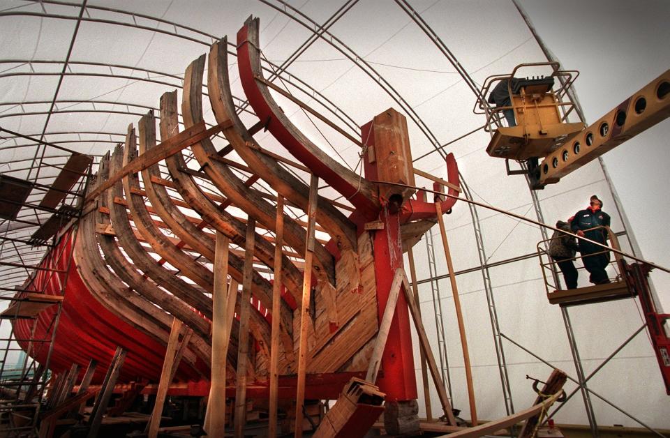 Volunteers finish up securing a protective plastic tarp over the Wisconsin Lake Schooner project on Dec. 2, 1997. The 137-foot-long sailing craft is being built by volunteers and donated funds.

The schooner would later be named the Denis Sullivan.