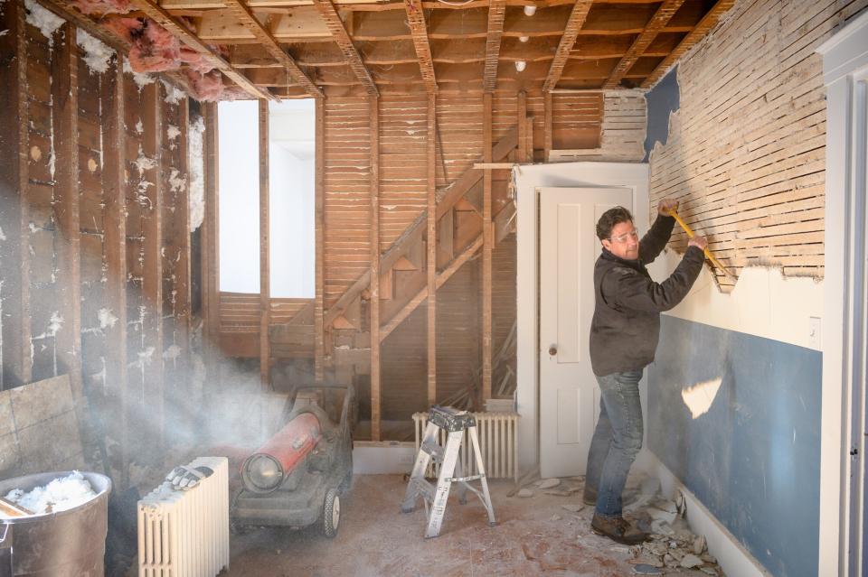 Jonathan Knight works on the demolition downstairs at his personal farmhouse in Boston, MA, as seen on Farmhouse Fixer. (interior) (before)