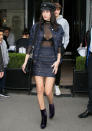 <p>The beauty was seen in Paris wearing a dark denim jacket and coordinating skirt with a sheer black top. Purple velvet booties, a newsboy hat, and textured black bag finished her ensemble.</p>