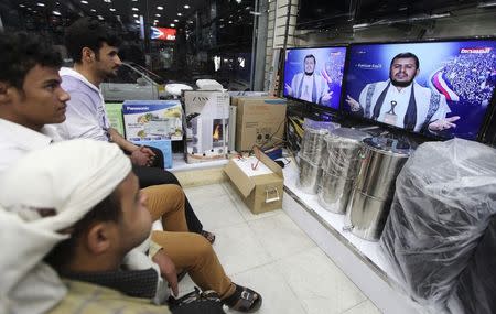 People watch as leader of Yemen's Houthi movement Abdel Malek al-Houthi delivers a live speech in Sanaa January 20, 2015. REUTERS/Mohamed al-Sayaghi