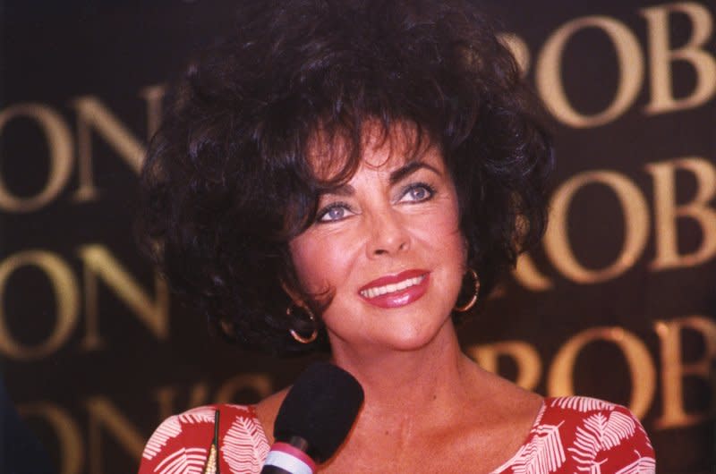 Elizabeth Taylor, making her first appearance since marrying for the eighth time four days earlier, holds a press conference to promote her new fragrance White Diamonds in Torrence, Calif., on October 10, 1991. Many reporters asked questions about Taylor's wedding, held at Michael Jackson's ranch. File Photo by Jim Ruymen/UPI