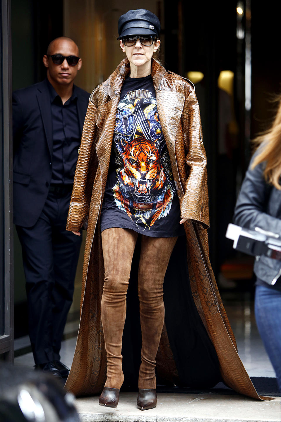 Canadian singer Celine Dion wears a long leather coat as she leaves her hotel in Paris