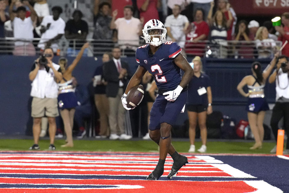 Arizona wide receiver Jacob Cowing scores a touchdown against Colorado during the first half of an NCAA college football game Saturday, Oct. 1, 2022, in Tucson, Ariz. (AP Photo/Rick Scuteri)