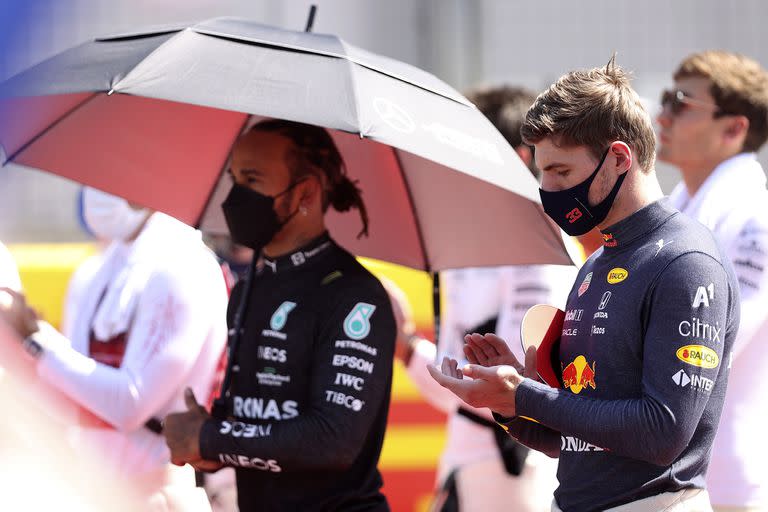 Red Bull driver Max Verstappen of the Netherlands and Mercedes driver Lewis Hamilton of Britain, left, stand on the grid before the start of the British Formula One Grand Prix, at the Silverstone circuit, in Silverstone, England, Sunday, July 18, 2021. (Lars Baron/Pool photo via AP)