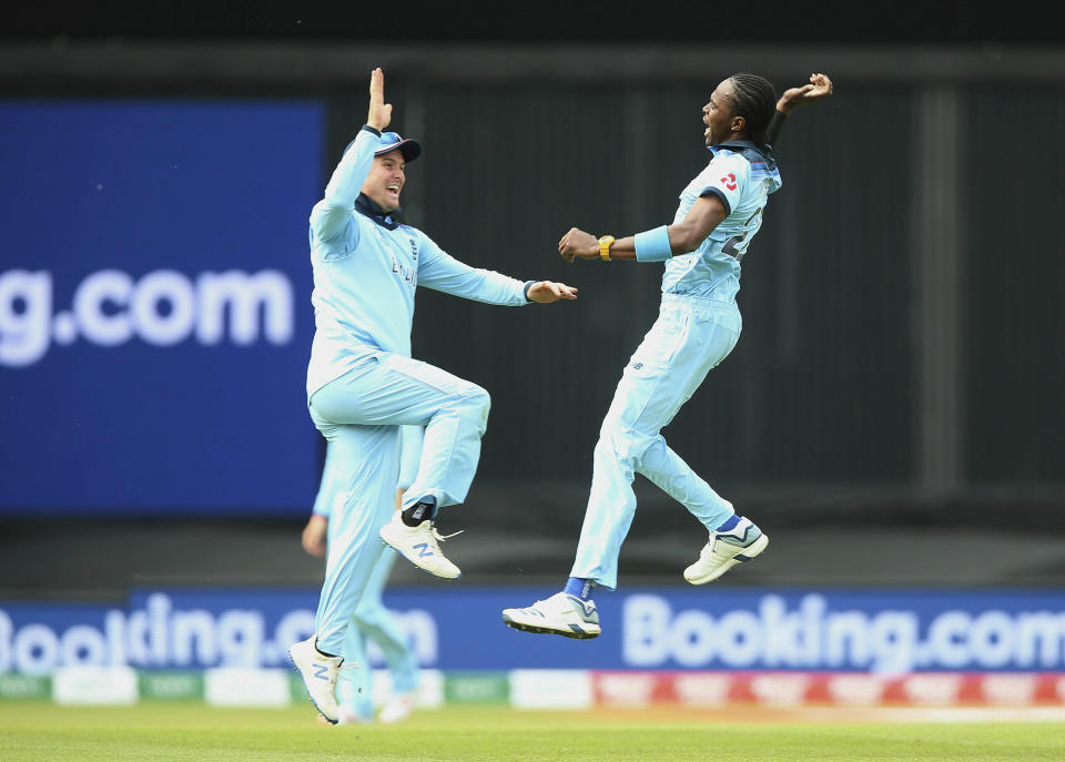 England's Jofra Archer, right, celebrates with teammate Jason Roy after taking the wicket of South Africa's Aiden Markram during their Cricket World Cup match at the Oval in London, Thursday, May 30, 2019. (Nigel French/PA via AP)