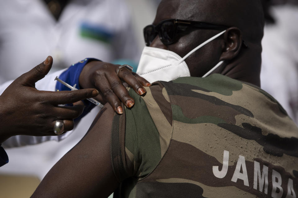 FILE — In this Tuesday, Feb. 23, 2021 file photo, a member of the Army Forces receives the China's Sinopharm vaccine during the start of the vaccination campaign against the COVID-19 at the Health Ministry in Dakar, Senegal. The director of the Africa Centers for Disease Control and Prevention says that as Africa strives to vaccinate 60% of its 1.3 billion people as quickly as possible, the continent must develop its capacity to produce COVID-19 vaccines. (AP Photo/Leo Correa, File)