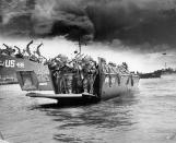 American soldiers disembark from an LCI landing craft upon its arrival on the beaches of Normandy for Operation Overlord, aka the D-Day invasion of Europe, on June 6, 1944. (Photo from Cynthia Johnson/The LIFE Images Collection/Getty Images)