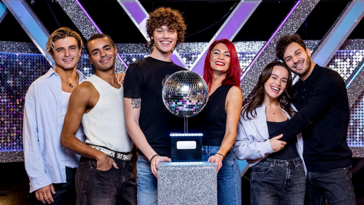  Strictly Come Dancing 2023 finalists Nikita Kuzmin, Layton Williams, Bobby Brazier, Dianne Buswell, Ellie Leach & Vito Coppola all standing around the glitterball trophy. 