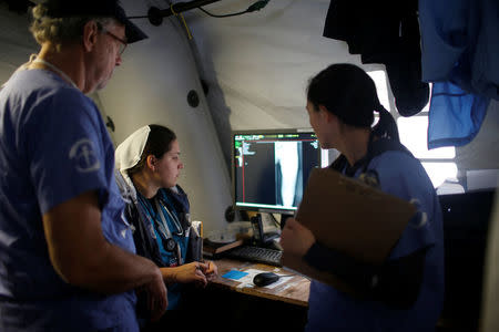 Foreign volunteers work at the emergency field hospital which is run by the US Christian charity Samaritan's Purse, eastern Mosul, Iraq March 22, 2017. Picture taken March 22, 2017. REUTERS/Suhaib Salem