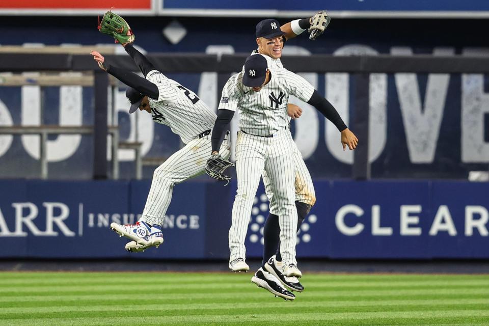 Apr 24, 2024; Bronx, New York, USA; New York Yankees left fielder Alex Verdugo (24), center fielder Aaron Judge (99), and right fielder Juan Soto (22) celebrate after defeating the Oakland Athletics 7-3 at Yankee Stadium. Mandatory Credit: Wendell Cruz-USA TODAY Sports