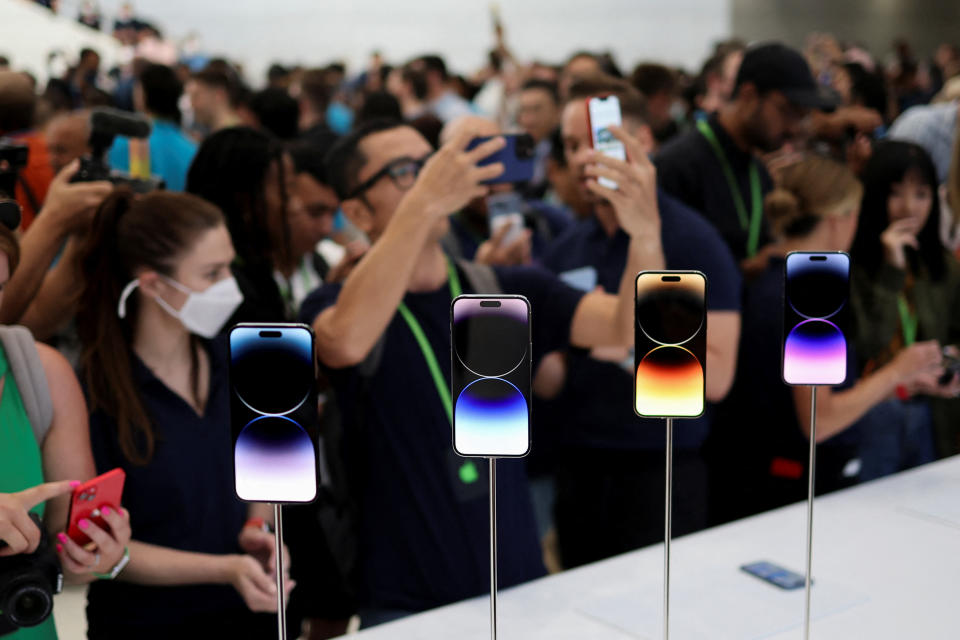 A guest looks at the new iPhone 14 at an Apple event at their headquarters in Cupertino, California, U.S. September 7, 2022. REUTERS/Carlos Barria