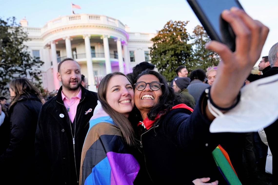 Aparna Shrivastava, right, takes a photo with Shelby Teeter after President Joe Biden signed the Respect for Marriage Act, Tuesday, Dec. 13, 2022, on the South Lawn of the White House in Washington.