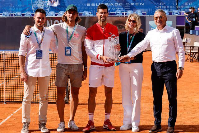 <p>Srdjan Stevanovic/Getty</p> Novak Djokovic poses alongside his brothers Djordje Djokovic and Marko Djokovic, and their parents, Dijana and Srdjan, after his men's singles final match at the ATP 250 Belgrade Open in Serbia on May 29, 2021.