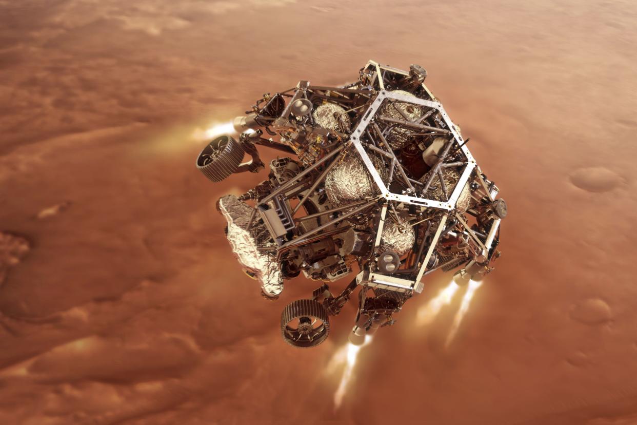In this illustration provided by NASA, the Perseverance rover fires up its descent stage engines as it nears the Martian surface.