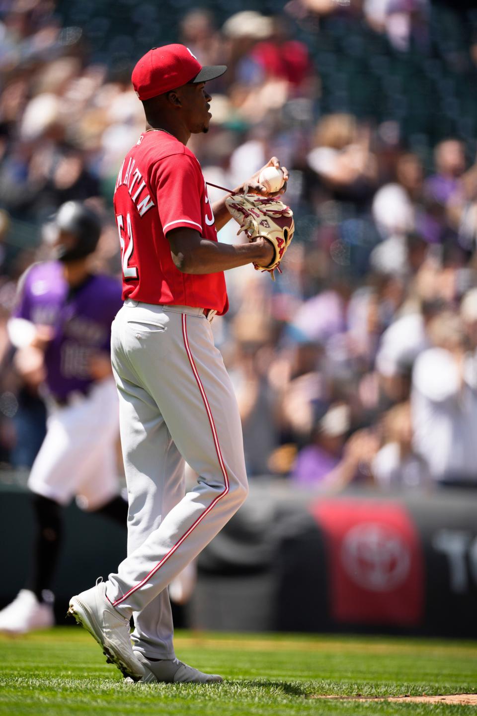 Cincinnati Reds starting pitcher Reiver Sanmartin reacts after giving up a two-run home run to Colorado Rockies' C.J. Cron in the first inning of a baseball game Sunday, May 1, 2022, in Denver.