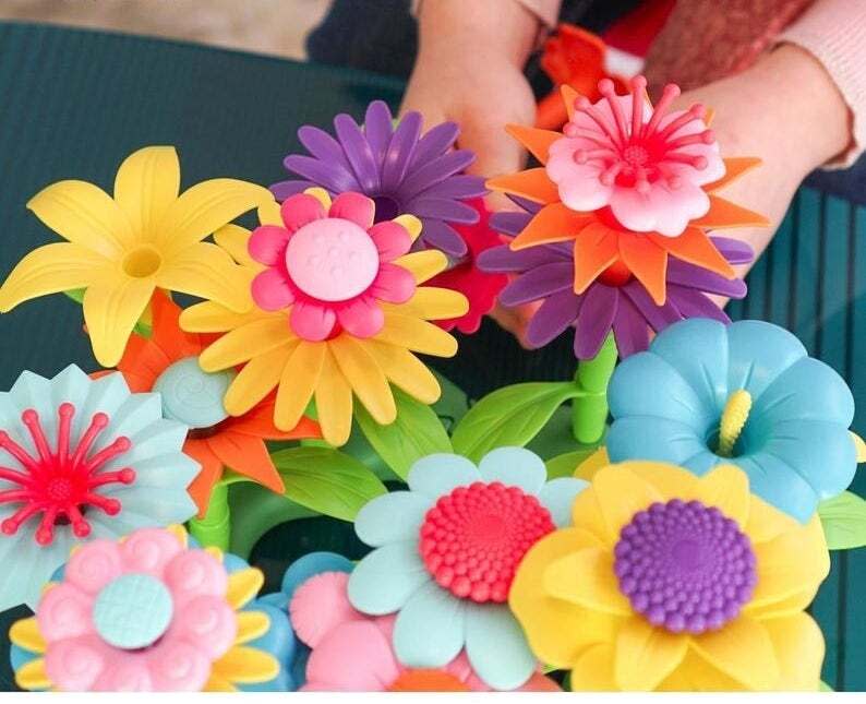 This 112-piece set will help give any aspiring botanist or florist a start &mdash; with no dirt tracked into the house. <br /><br />BTW: Axel Adventures is an Etsy shop and family-run online toy store established in 2020 and based in Nevada.<br /><br /><strong>Promising review:</strong> "The flowers are a big hit, and arrived on time!" &mdash; <a href="https://go.skimresources.com?id=38395X987171&amp;xs=1&amp;xcust=HPToddlerToys607dd44ee4b0df3610beec33&amp;url=https%3A%2F%2Fwww.etsy.com%2Fshop%2FSidewaysTees" target="_blank" rel="noopener noreferrer">Dean</a><br /><strong><br />Get it from <a href="https://go.skimresources.com?id=38395X987171&amp;xs=1&amp;xcust=HPToddlerToys607dd44ee4b0df3610beec33&amp;url=https%3A%2F%2Fwww.etsy.com%2Fshop%2FAxelAdventures" target="_blank" rel="noopener noreferrer">Axel Adventures</a> on Etsy for <a href="https://go.skimresources.com?id=38395X987171&amp;xs=1&amp;xcust=HPToddlerToys607dd44ee4b0df3610beec33&amp;url=https%3A%2F%2Fwww.etsy.com%2Flisting%2F871532016%2Fcolorful-build-a-flower-toy-building" target="_blank" rel="noopener noreferrer">$33.37</a>.</strong>