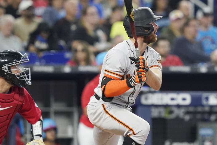 San Francisco Giants second baseman Donovan Walton (37) watches his hit go deep into left field during the fourth inning of a baseball game against the Miami Marlins, Saturday, June 4, 2022, in Miami. The Giants scored three runs on the play. (AP Photo/Marta Lavandier)