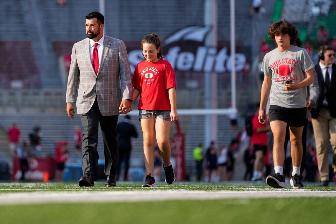 Sep 17, 2022; Columbus, Ohio, USA; Ohio State Buckeyes head coach Ryan Day walks across the field with his daughter, Nia, and son, RJ, prior to the NCAA Division I football game against the Toledo Rockets at Ohio Stadium.