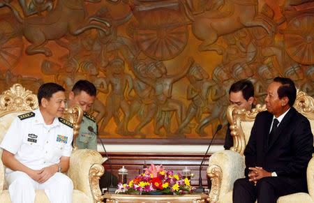 Captain Wang Hong Li (L), Commanding Officer of the 23rd Chinese Naval Escort Task Force, smiles as Cambodia's Defense Minister Tea Banh (R) speaks during a meeting at the Ministry of National Defense of Cambodia, in Phnom Penh, Cambodia October 17, 2016. REUTERS/Samrang Pring