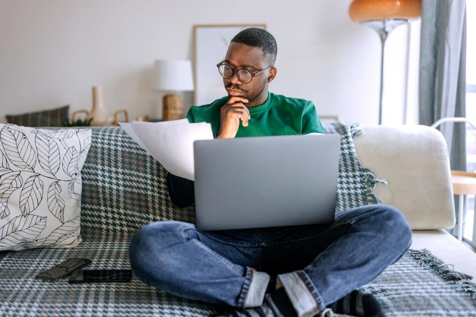 A man works on his taxes ng room.