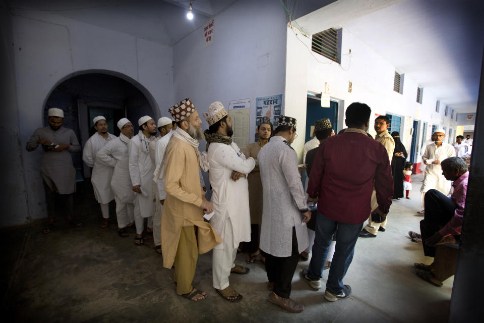 Indian Muslims stand in a queue to cast their votes at a polling station in Varanasi, India, Sunday, May 19, 2019. Indians are voting in the seventh and final phase of national elections, wrapping up a 6-week-long long, grueling campaign season with Prime Minister Narendra Modi's Hindu nationalist party seeking reelection for another five years. Counting of votes is scheduled for May 23. (AP Photo/Rajesh Kumar Singh)