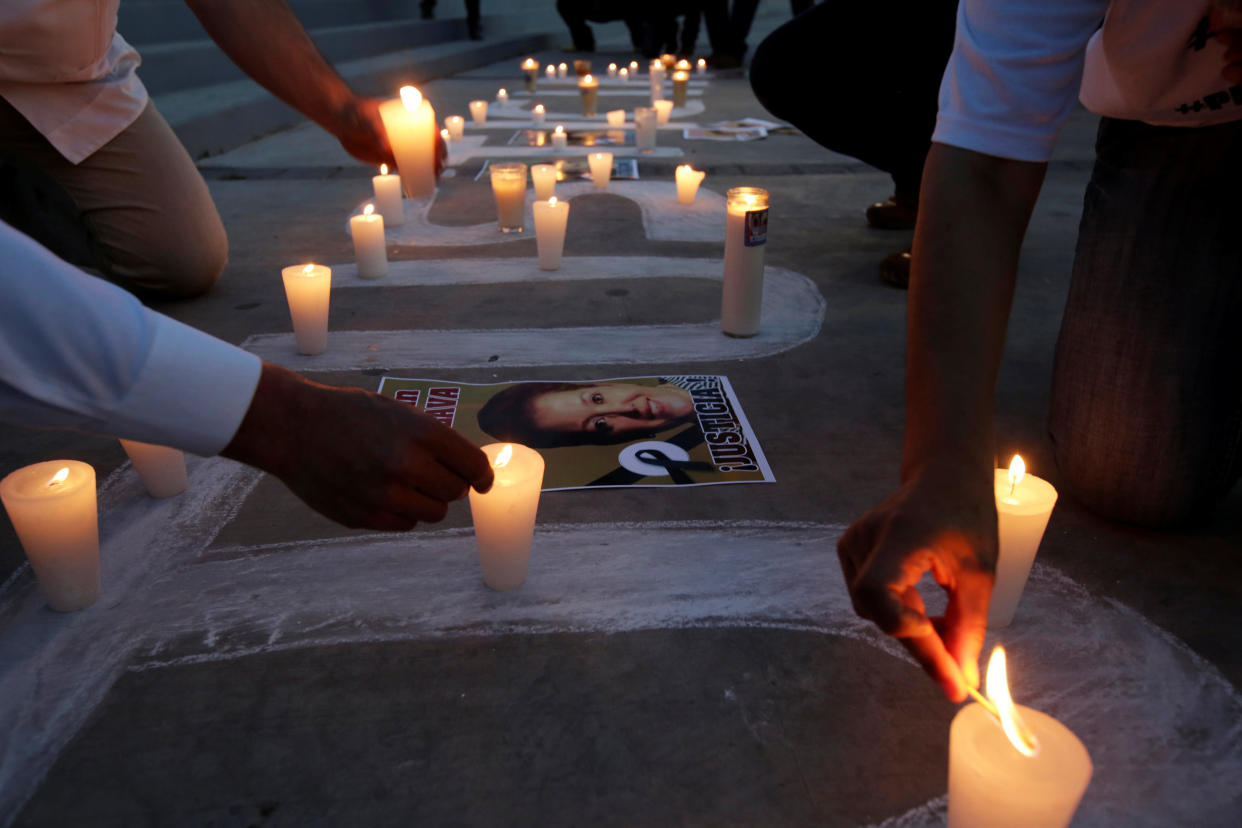 Journalists light candles during a protest to mark the first anniversary of the killing of their colleague Miroslava Breach. (Photo: Jose Luis Gonzalez/Reuters)