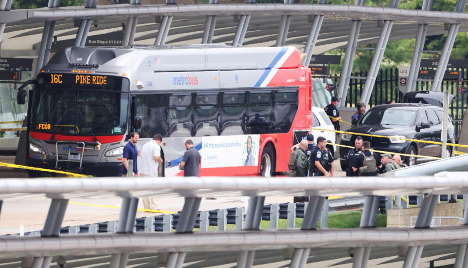 Police and officials work at the scene of a shooting in the Metro bus station outside the Pentagon in Arlington, Virginia. Source: AP