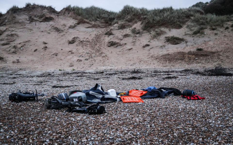 The remains of a damaged inflatable boat and a sleeping bag left by migrants on the beach near Wilmereux, France - Mohammed Badra/EPA-EFE/Shutterstock