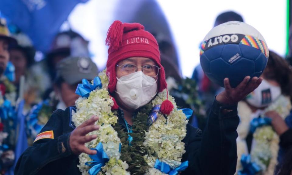 Luis Arce, the presidential candidate of Evo Morales’s Mas party, holds a ball during his closing rally in El Alto.