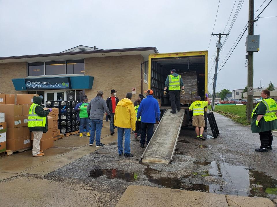 The Frenchtown Community Emergency Response Team helps at a food drive at the Opportunity Center at the Arthur Lesow Community Center in Monroe.