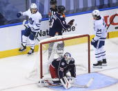 Toronto Maple Leafs right wing William Nylander (88) celebrates his goal with teammate Auston Matthews (34) as Columbus Blue Jackets goaltender Joonas Korpisalo (70) and teammate Zach Werenski (8) look on during the second period of an NHL hockey playoff game Thursday, Aug. 6, 2020, in Toronto. (Nathan Denette/The Canadian Press via AP)