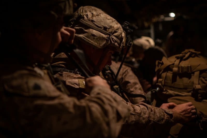 U.S. Marines assigned to Special Purpose Marine Air-Ground Task Force-Crisis Response-Central Command 19.2 prepare to deploy to reinforce Baghdad's U.S. embassy from a base in Kuwait