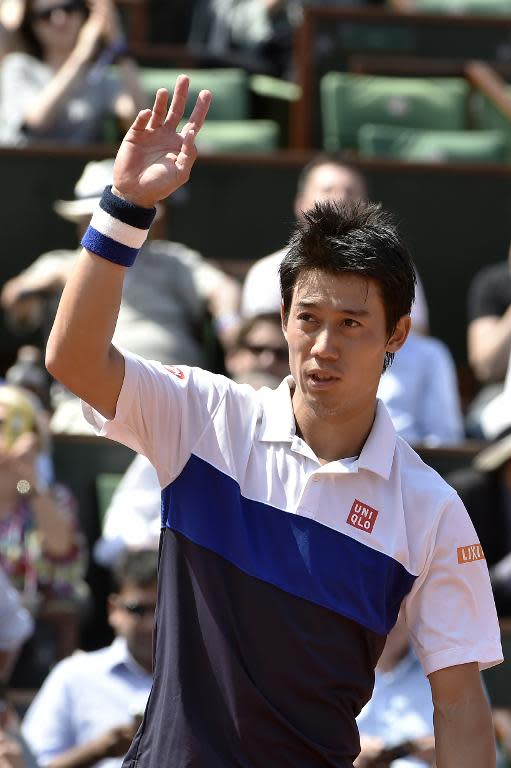 Kei Nishikori celebrates after defeating Thomaz Belluci at Roland Garros in Paris on May 27, 2015