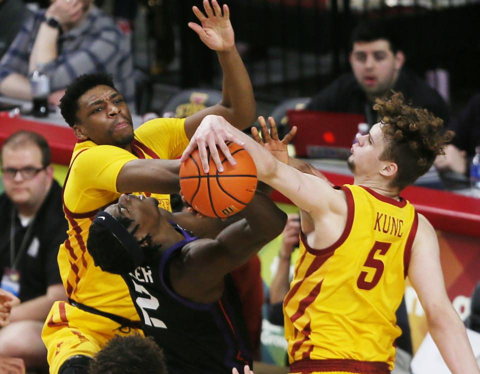 Iowa State's Osun Osunniyi, left, and Jaz Kunc, right, defend against TCU's Emanuel Miller during the second half of Wednesday's game at Hilton Coliseum in Ames.