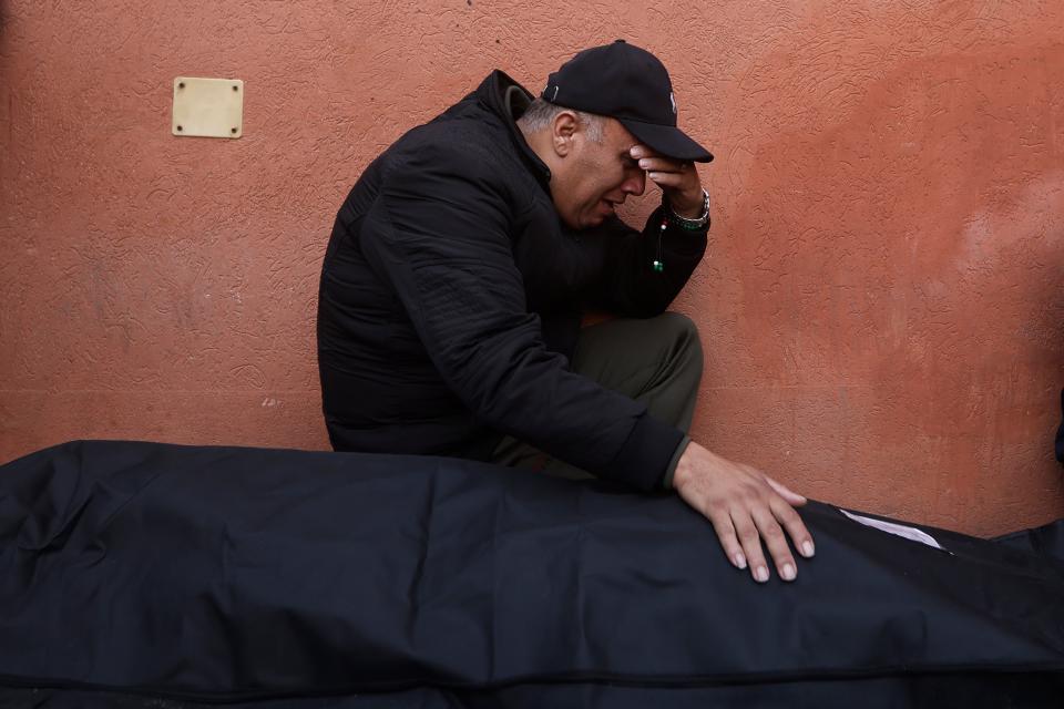 A Palestinian man cries next to his killed relative (AP)