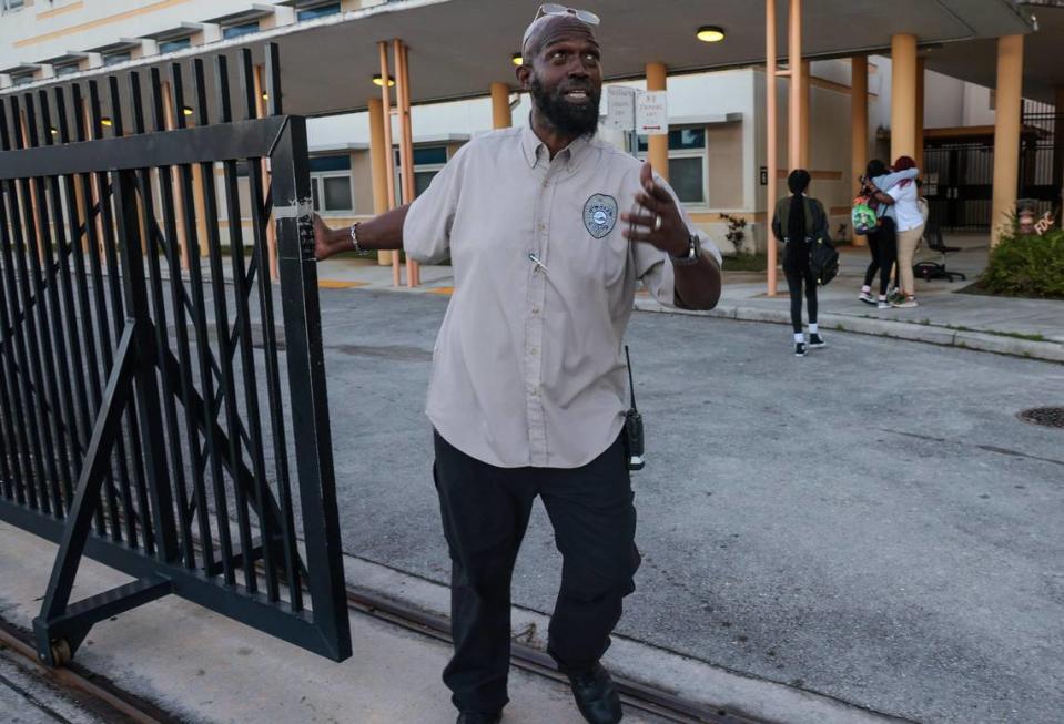 At Miami Carol Senior High School in Miami Gardens, Security guard Tony, who greeted several students by name, begins the process of closing the security gate as students greet one another.
